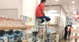 名创优品特色防盗，店员坐上梯子